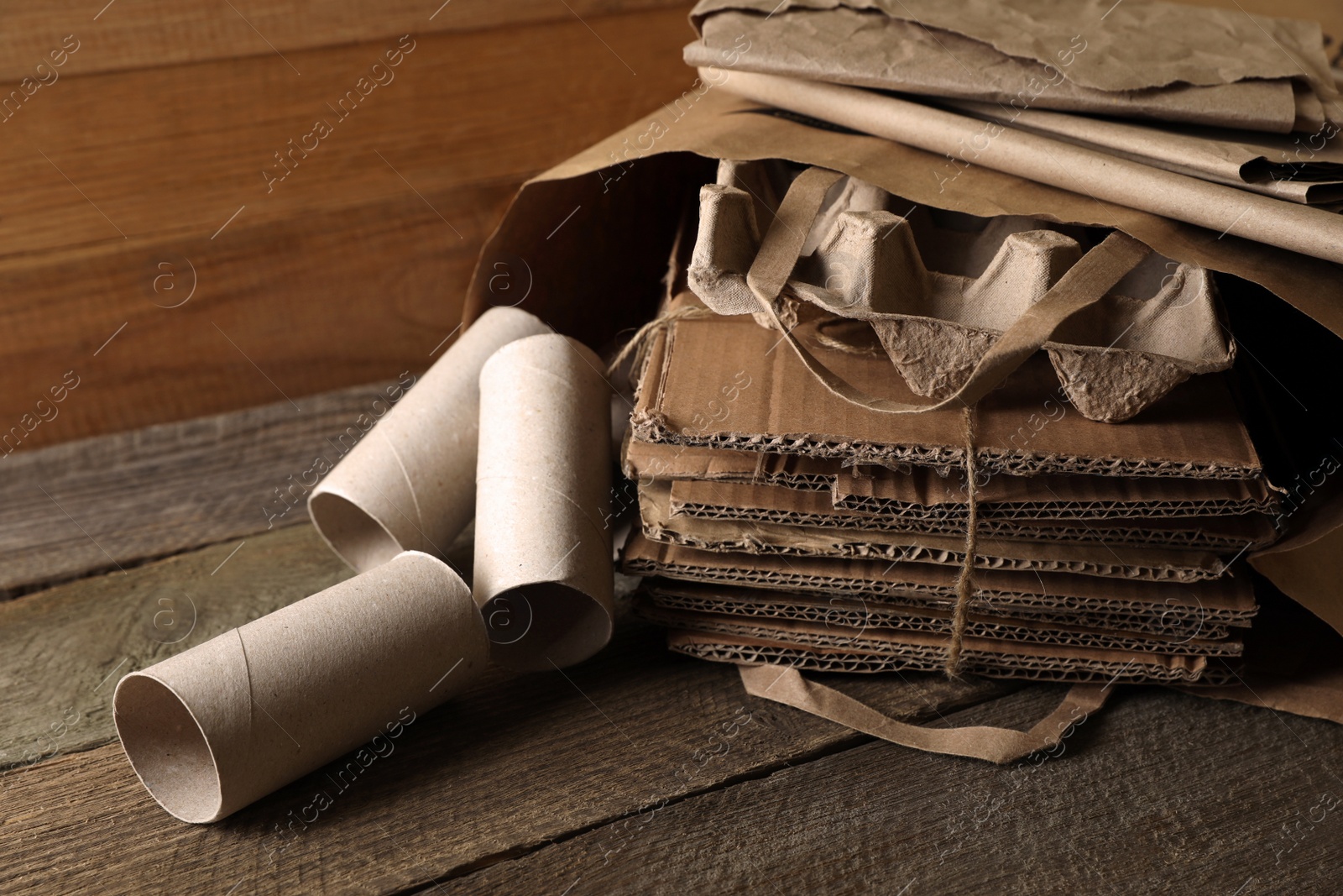 Photo of Different waste paper on wooden table, closeup