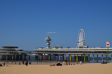 Photo of Hague, Netherlands - May 2, 2022: Beautiful view of beach and Scheveningen Pier with Ferris wheel