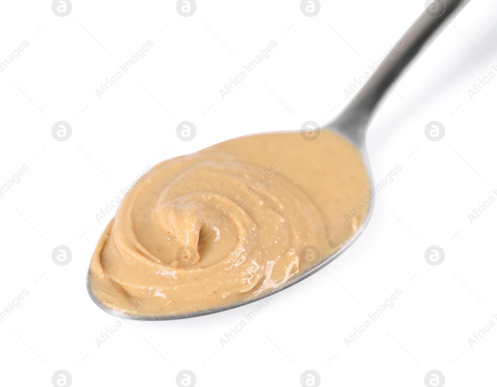 Photo of Delicious nut butter in spoon isolated on white