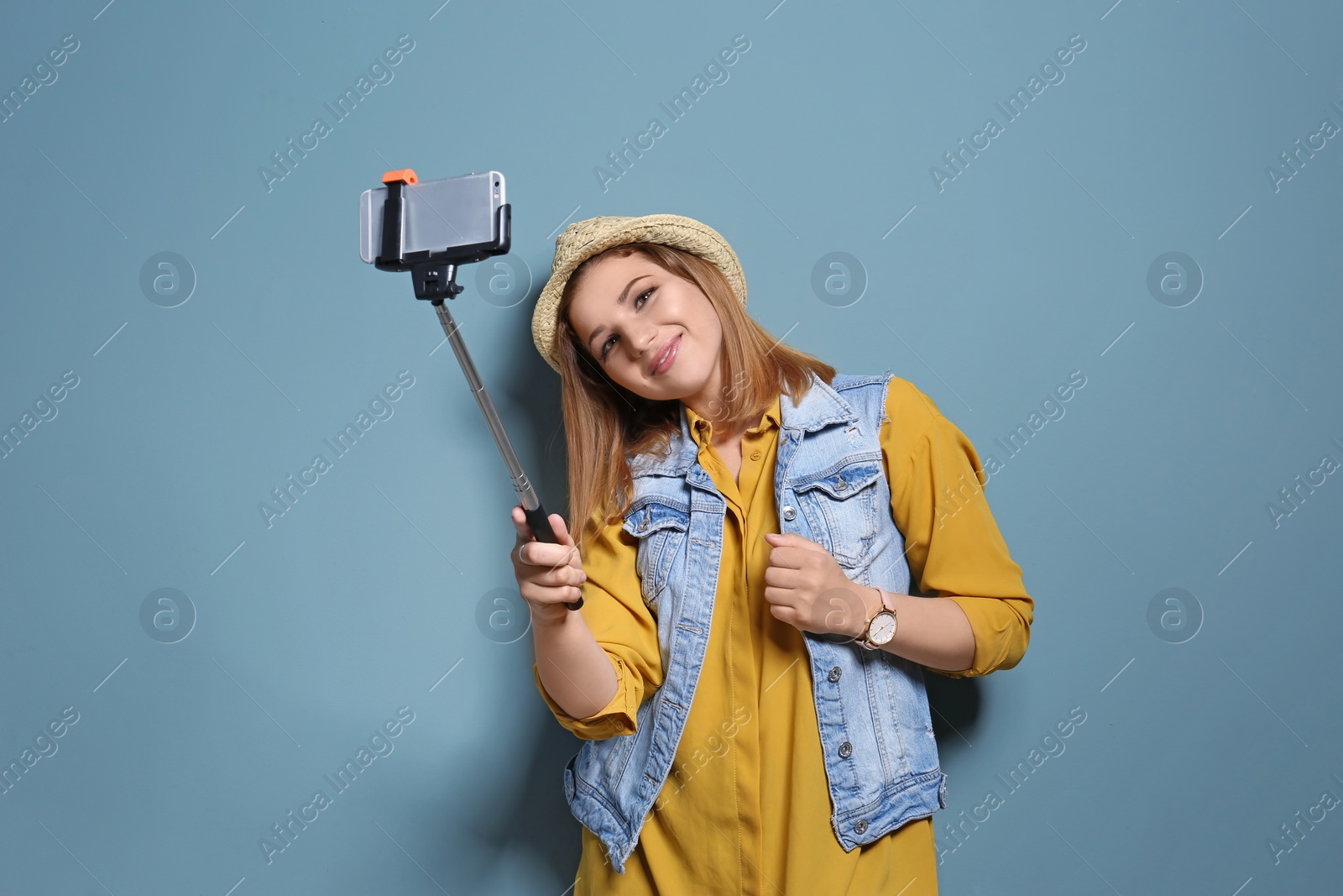 Photo of Attractive young woman taking selfie on color background