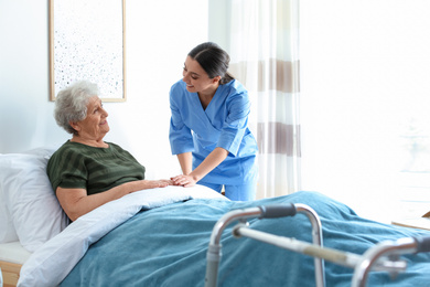 Photo of Care worker with elderly woman in geriatric hospice