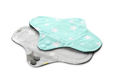 Photo of Cloth menstrual pads on white background. Reusable female hygiene product