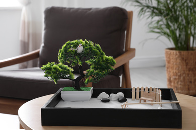 Photo of Beautiful miniature zen garden on wooden table indoors