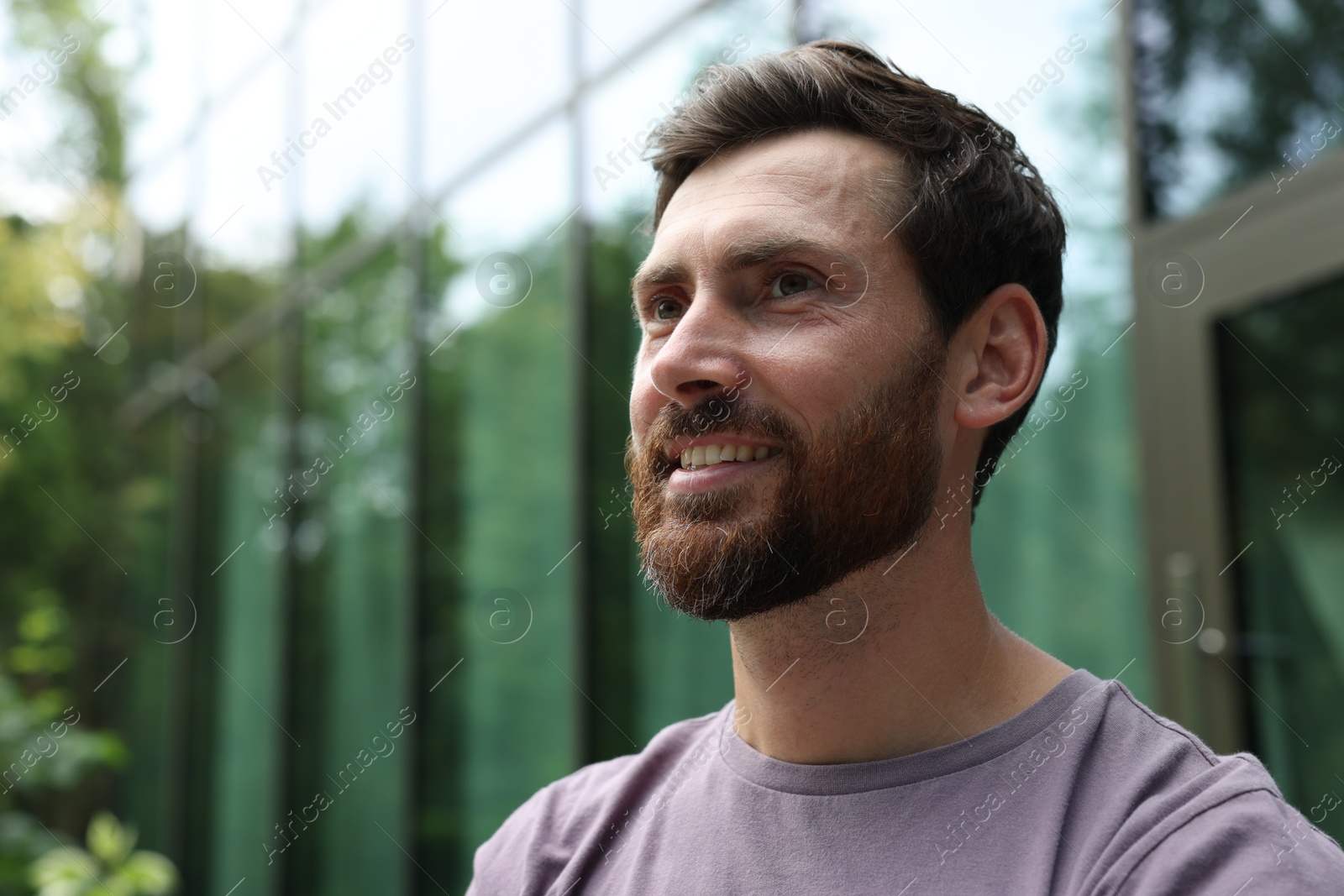 Photo of Portrait of handsome bearded man outdoors, space for text