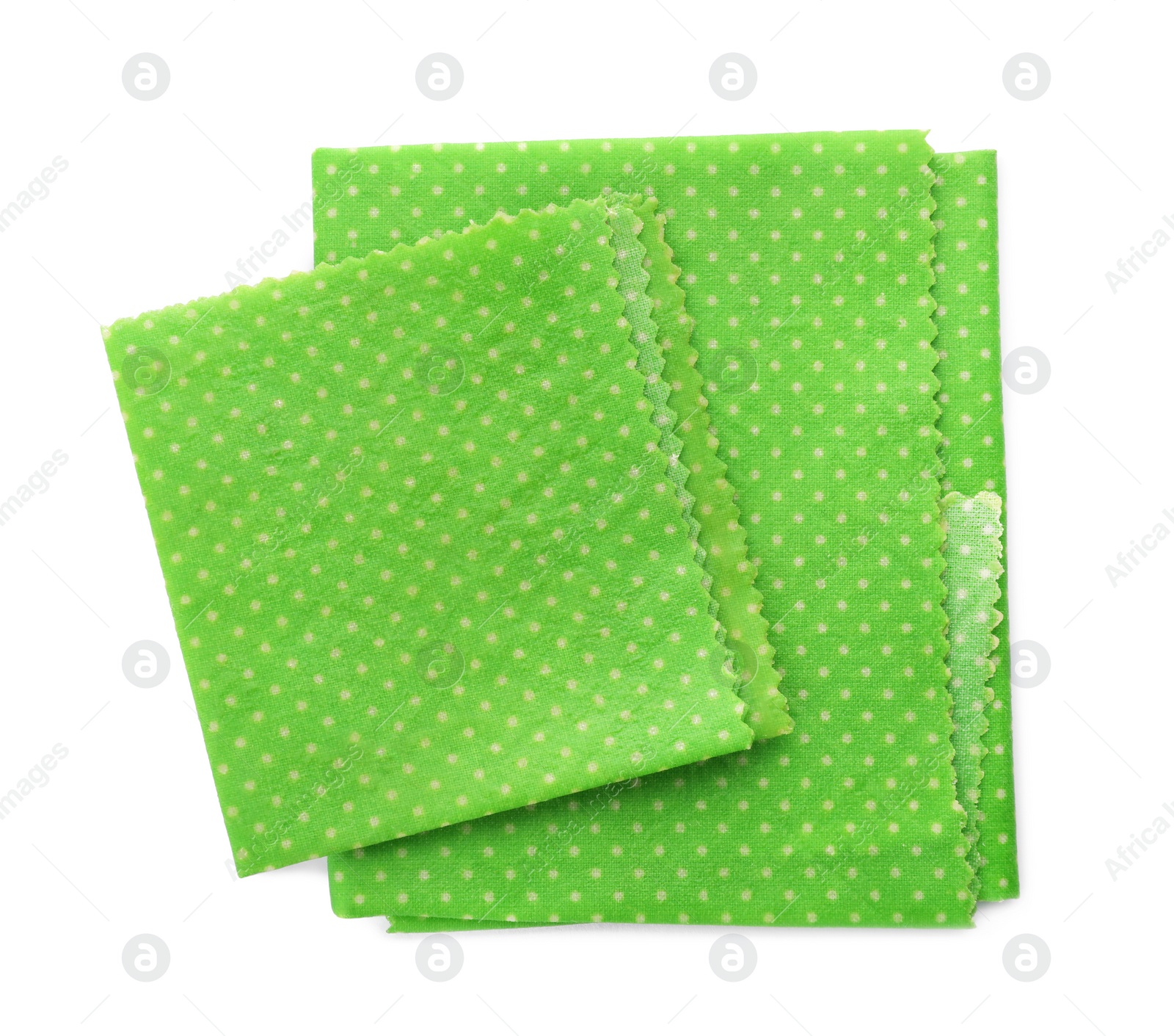 Photo of Green reusable beeswax food wraps on white background, top view