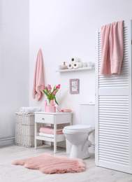 Interior of stylish bathroom with toilet bowl and decor elements