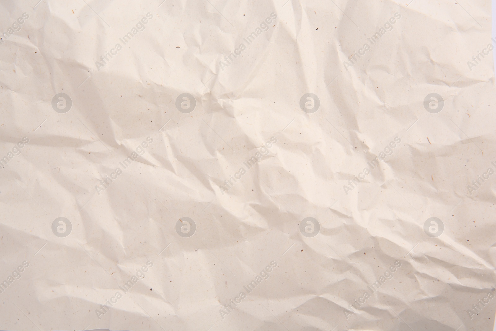 Photo of Texture of crumpled parchment paper as background, top view