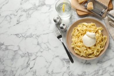Photo of Delicious pasta with burrata cheese served on white marble table, flat lay. Space for text