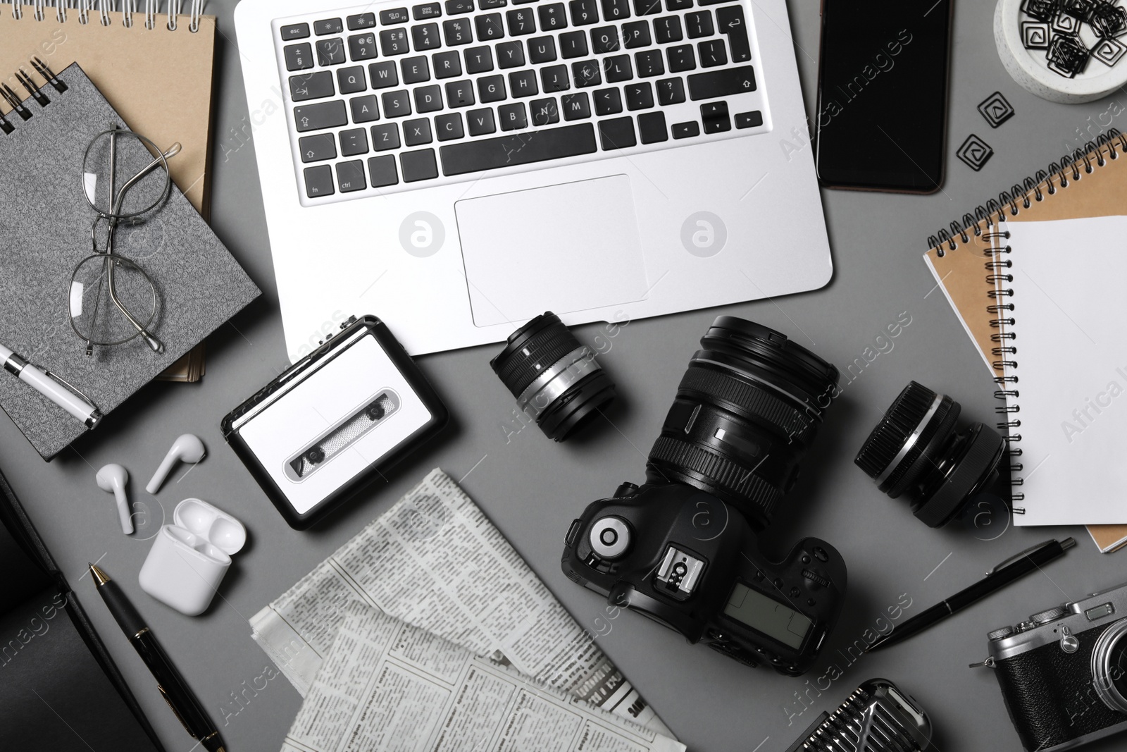 Photo of Flat lay composition with equipment for journalist on grey table