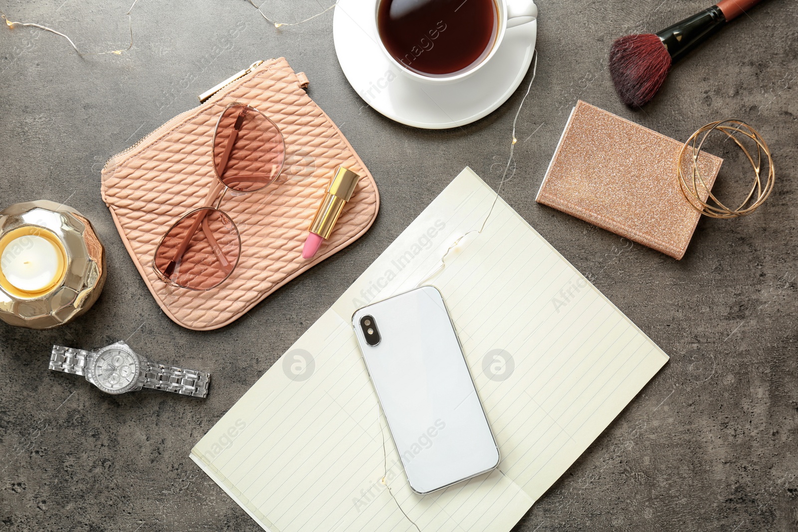 Photo of Flat lay composition with cup of coffee, smartphone and stylish accessories on grey background. Blogger concept