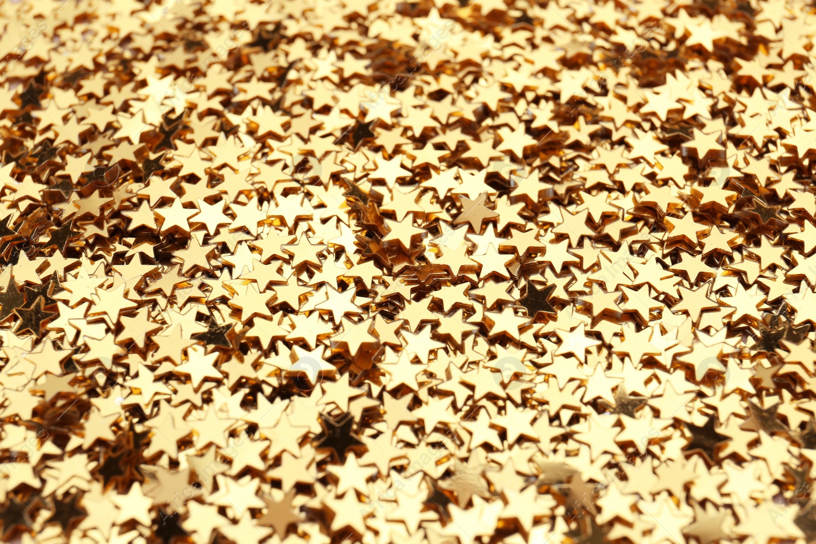 Photo of Confetti stars as background, closeup. Christmas celebration