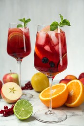 Delicious Red Sangria and fruits on white marble table