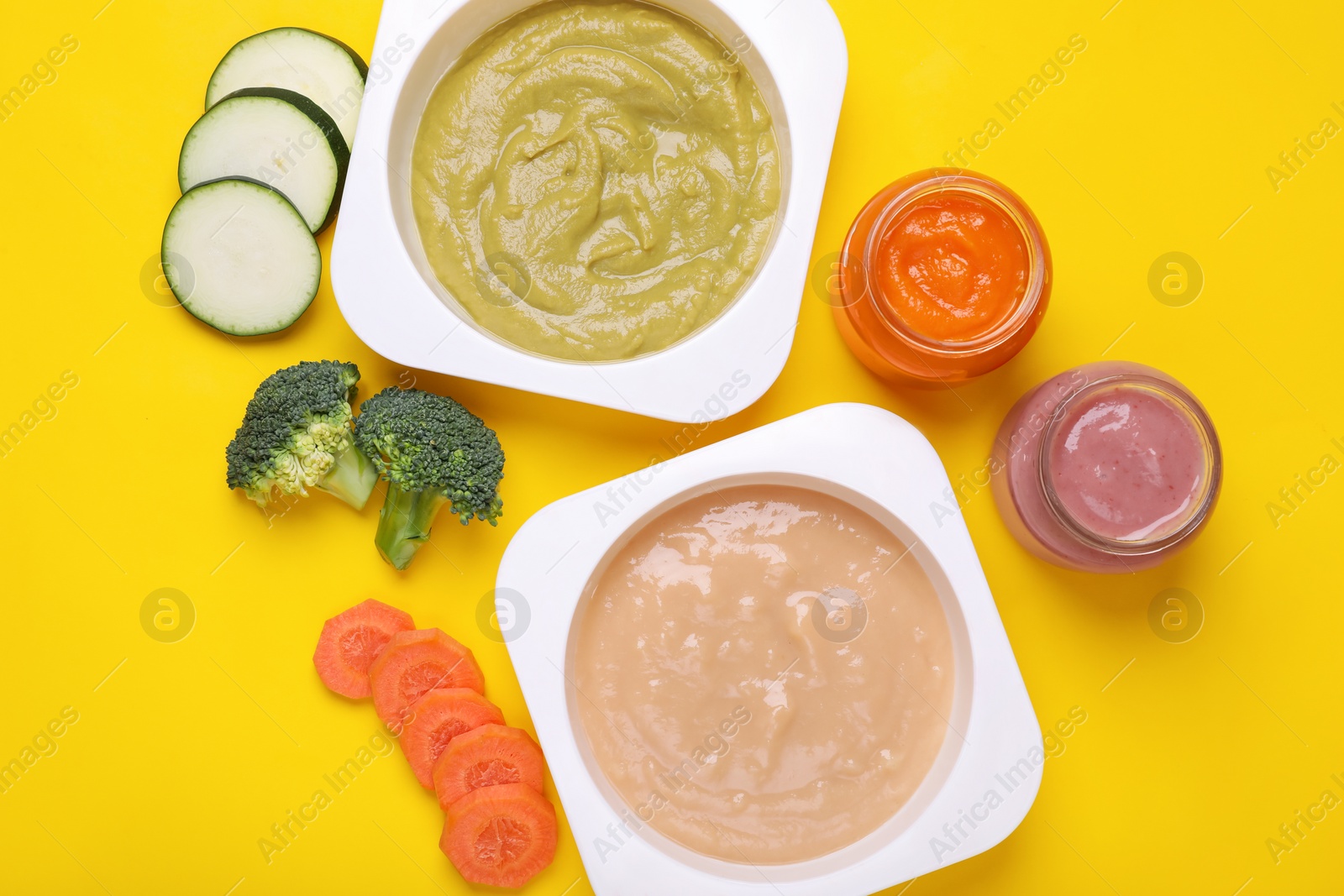 Photo of Flat lay composition with healthy baby food and ingredients on yellow background