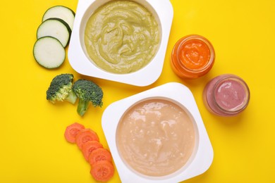 Photo of Flat lay composition with healthy baby food and ingredients on yellow background