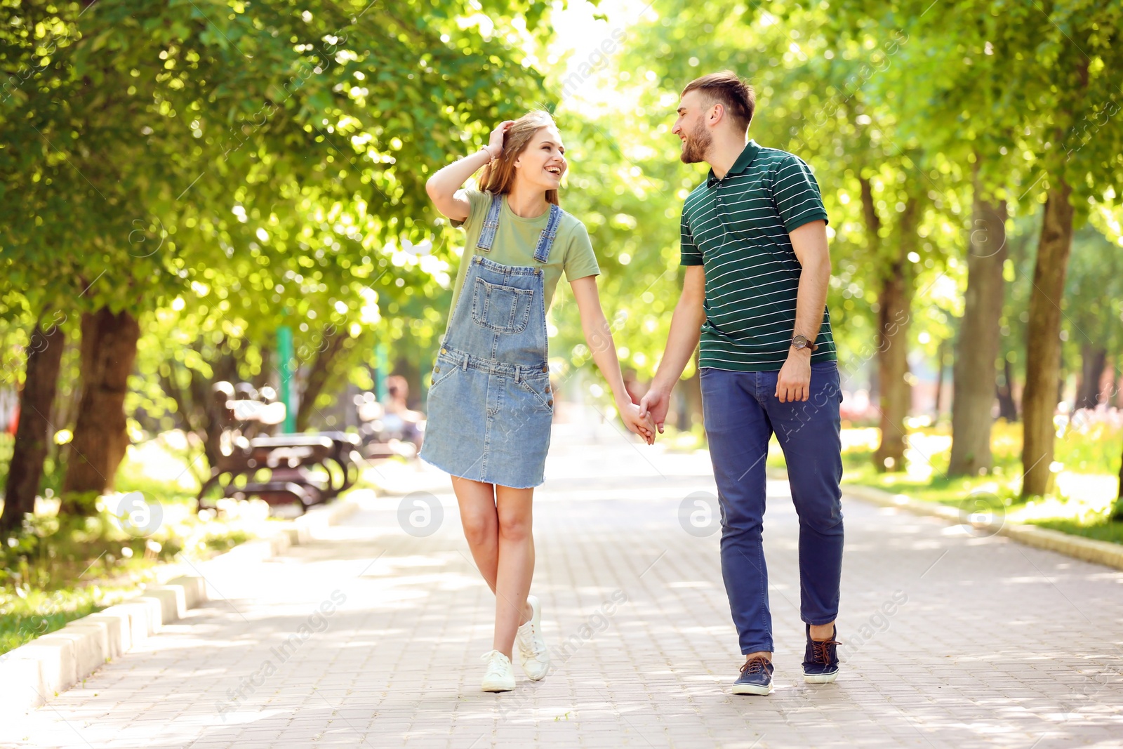 Photo of Happy young couple in green park on sunny spring day