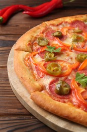 Delicious pizza Diablo on wooden table, closeup