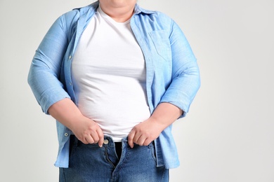 Photo of Overweight woman on light background