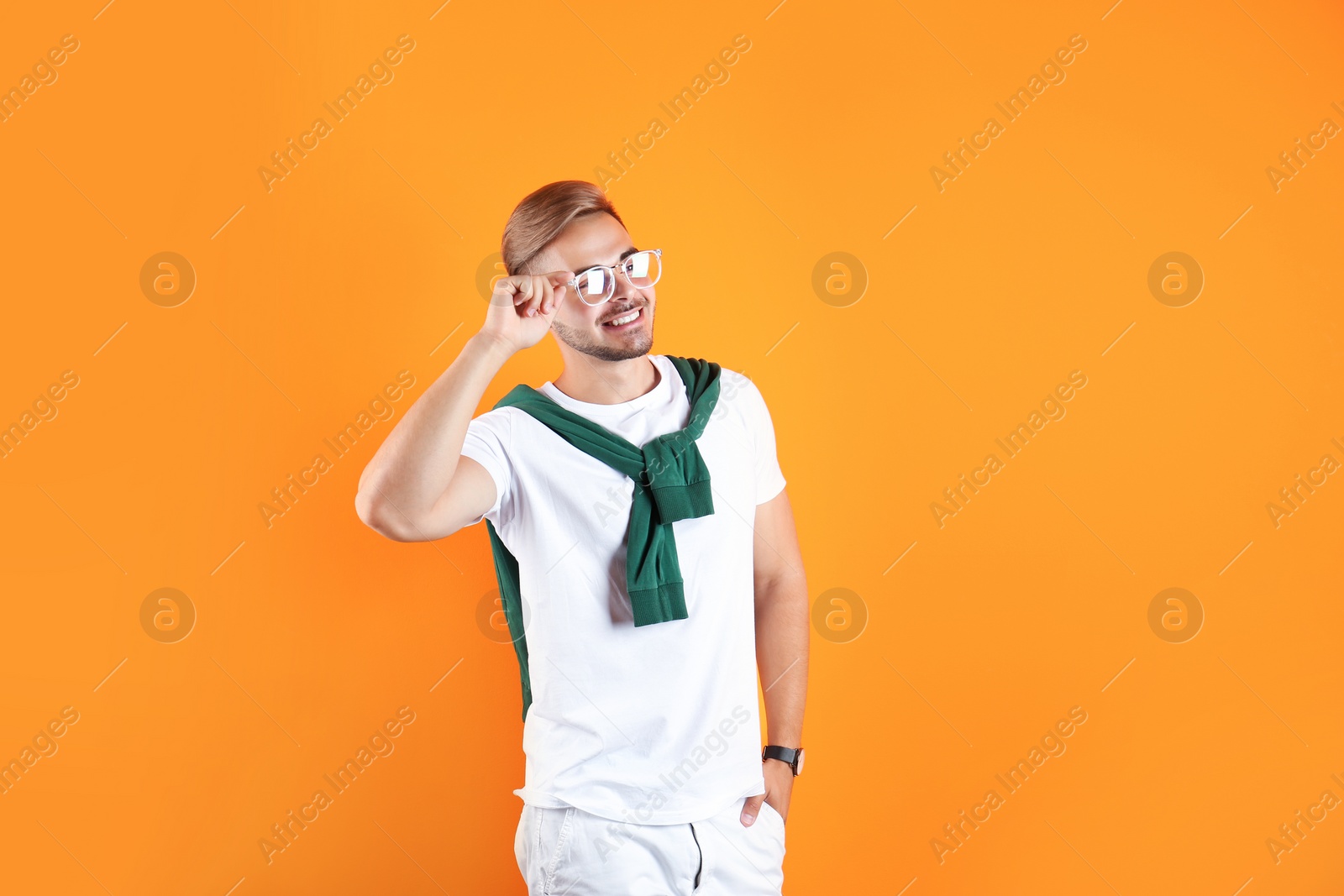 Photo of Young man with trendy hairstyle on color background