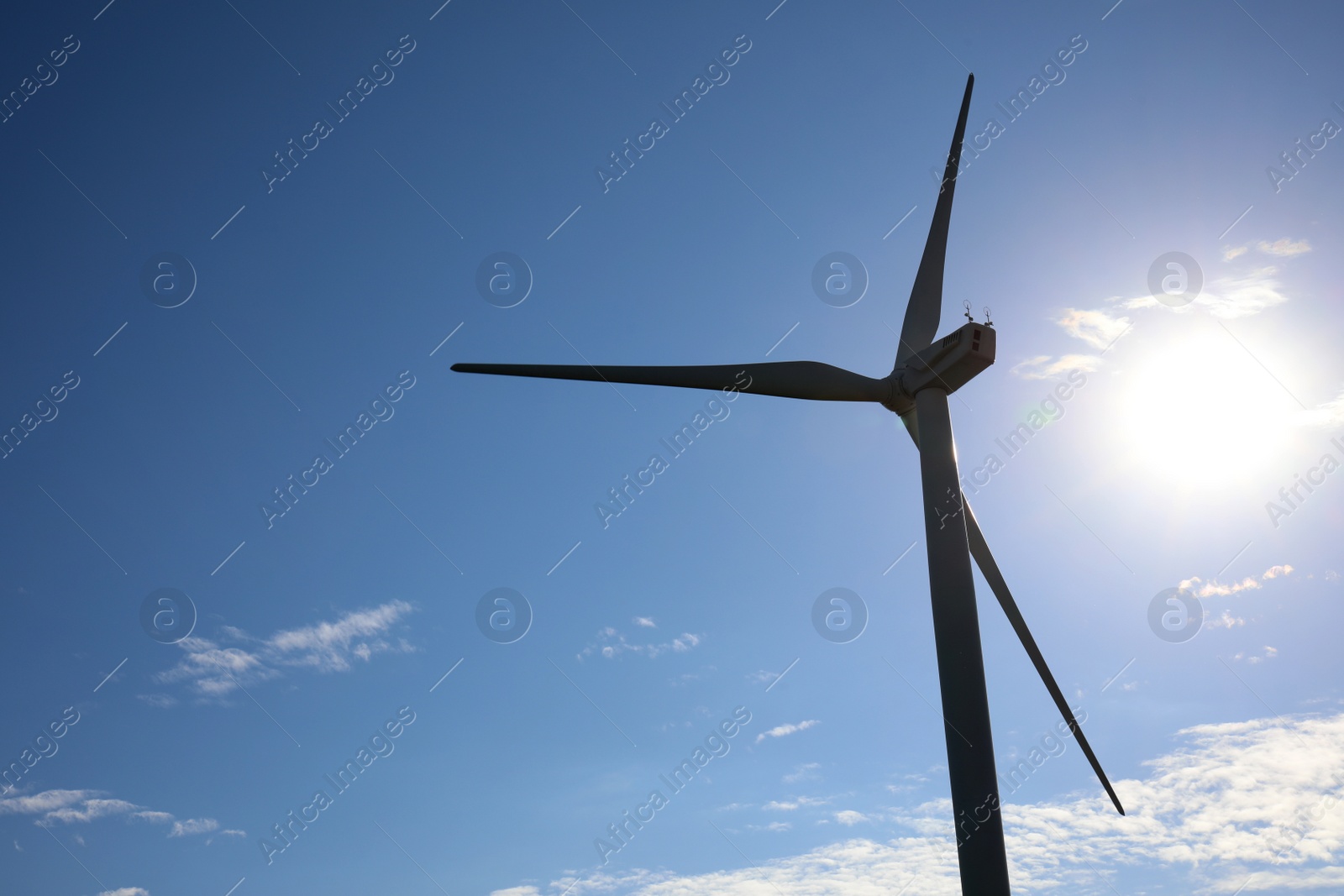 Photo of Wind turbine against beautiful blue sky. Alternative energy source