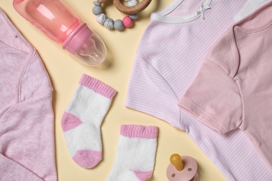 Photo of Flat lay composition with cute baby items on beige background