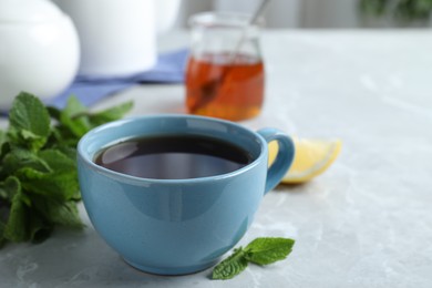 Photo of Fresh tea with mint on light table