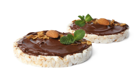 Photo of Puffed rice cakes with chocolate spread, nuts and mint isolated on white