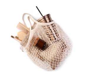 Mesh bag with different items isolated on white, top view. Conscious consumption