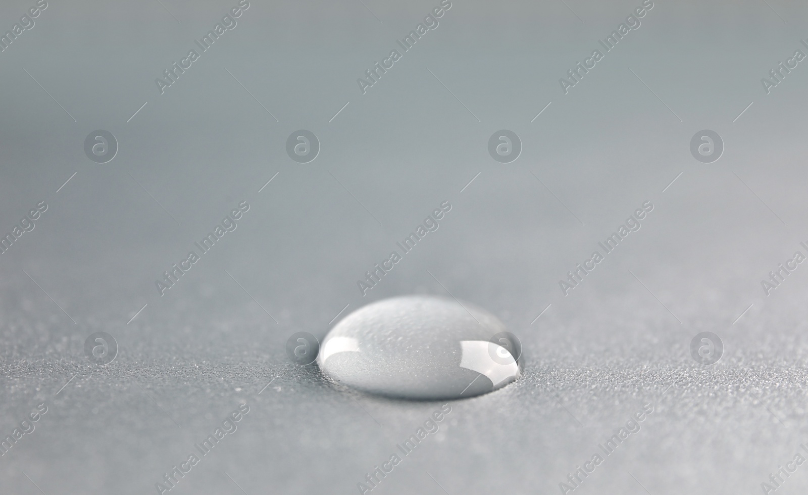 Photo of Beautiful clean water drop on light background