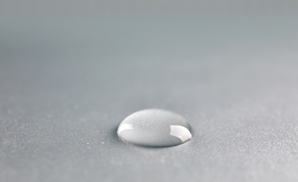 Beautiful clean water drop on light background