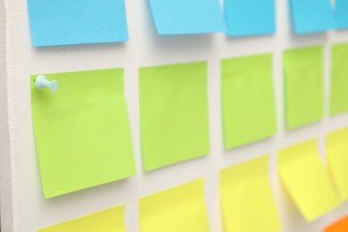 Photo of Blank colorful paper notes on white board, closeup