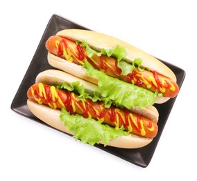 Tasty hot dogs with lettuce, ketchup and mustard isolated on white, top view