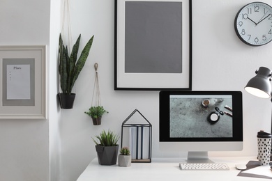 Photo of Stylish workplace with modern computer on desk