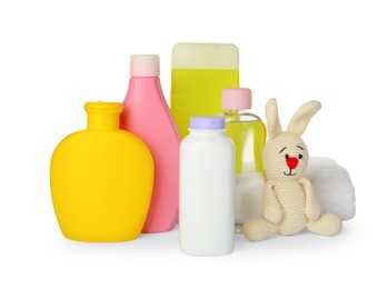 Set of baby cosmetic products, toy bunny and towel on white background