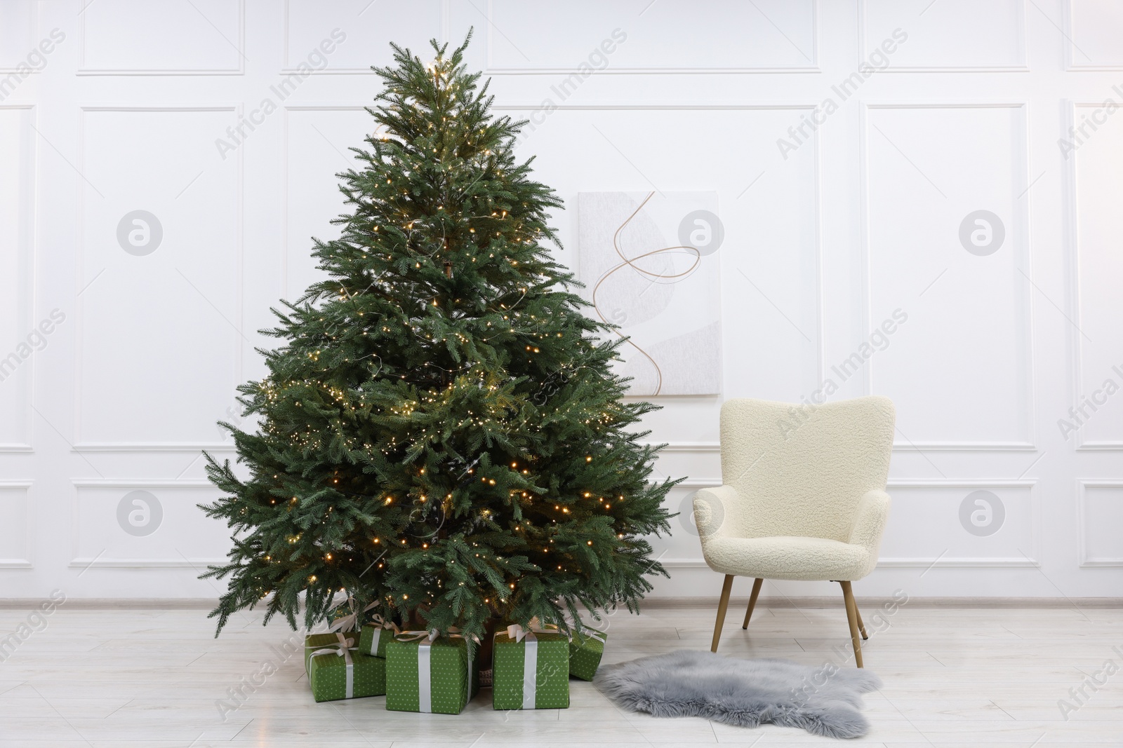 Photo of Many different gift boxes under Christmas tree indoors