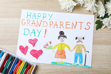 Photo of Beautiful drawing on wooden table, flat lay. Happy Grandparents Day