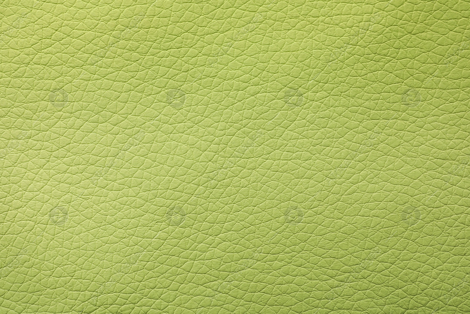 Photo of Texture of light green leather as background, closeup