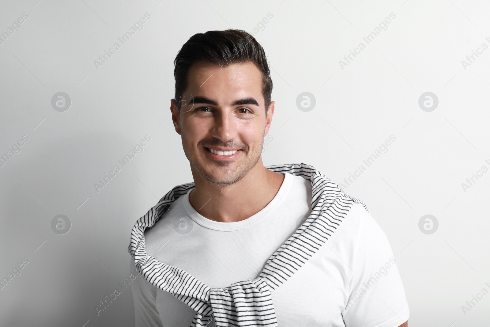 Photo of Portrait of handsome young man on white background