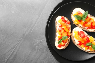 Photo of Tasty fresh tomato bruschettas on grey table, flat lay. Space for text