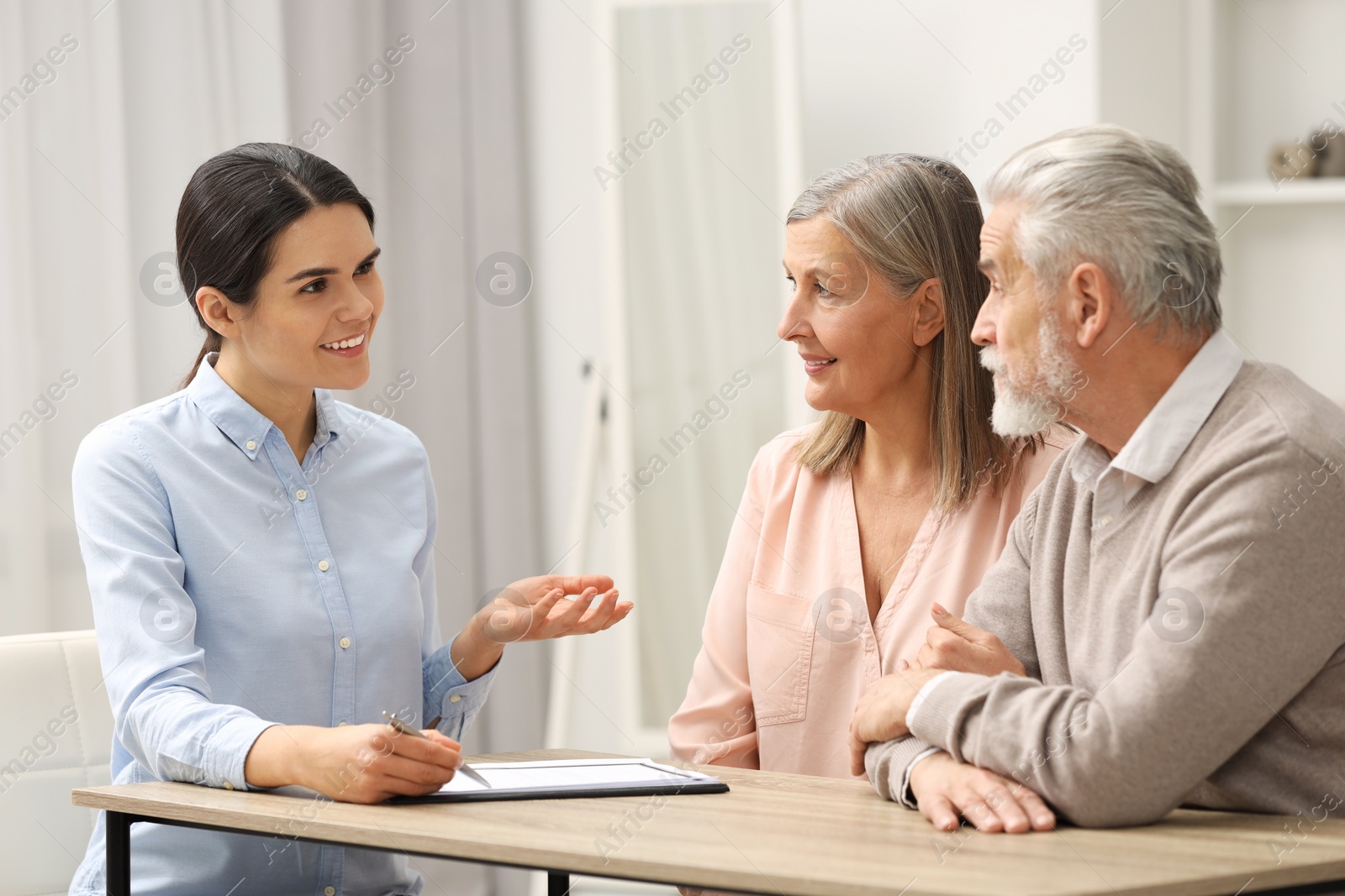 Photo of Notary consulting senior couple about Last Will and Testament in office