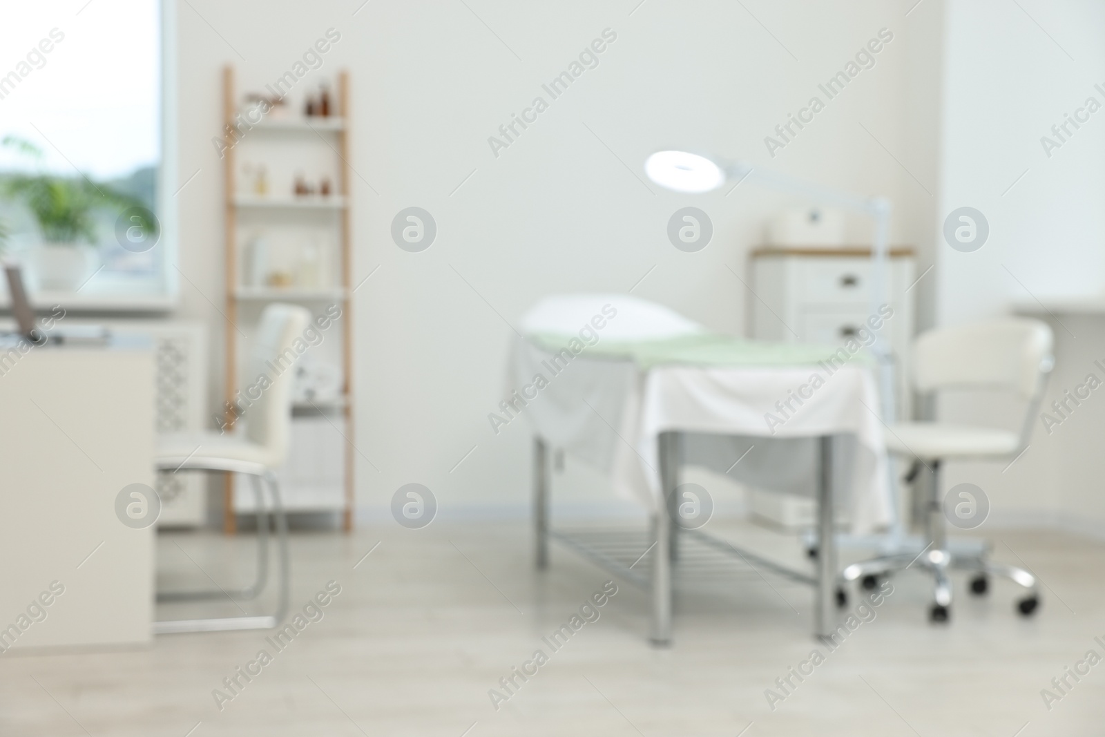 Photo of Modern interior of dermatologist's office with examination table