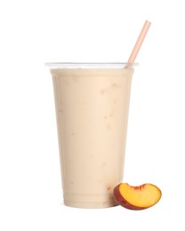 Photo of Plastic cup of tasty smoothie and fresh peach isolated on white