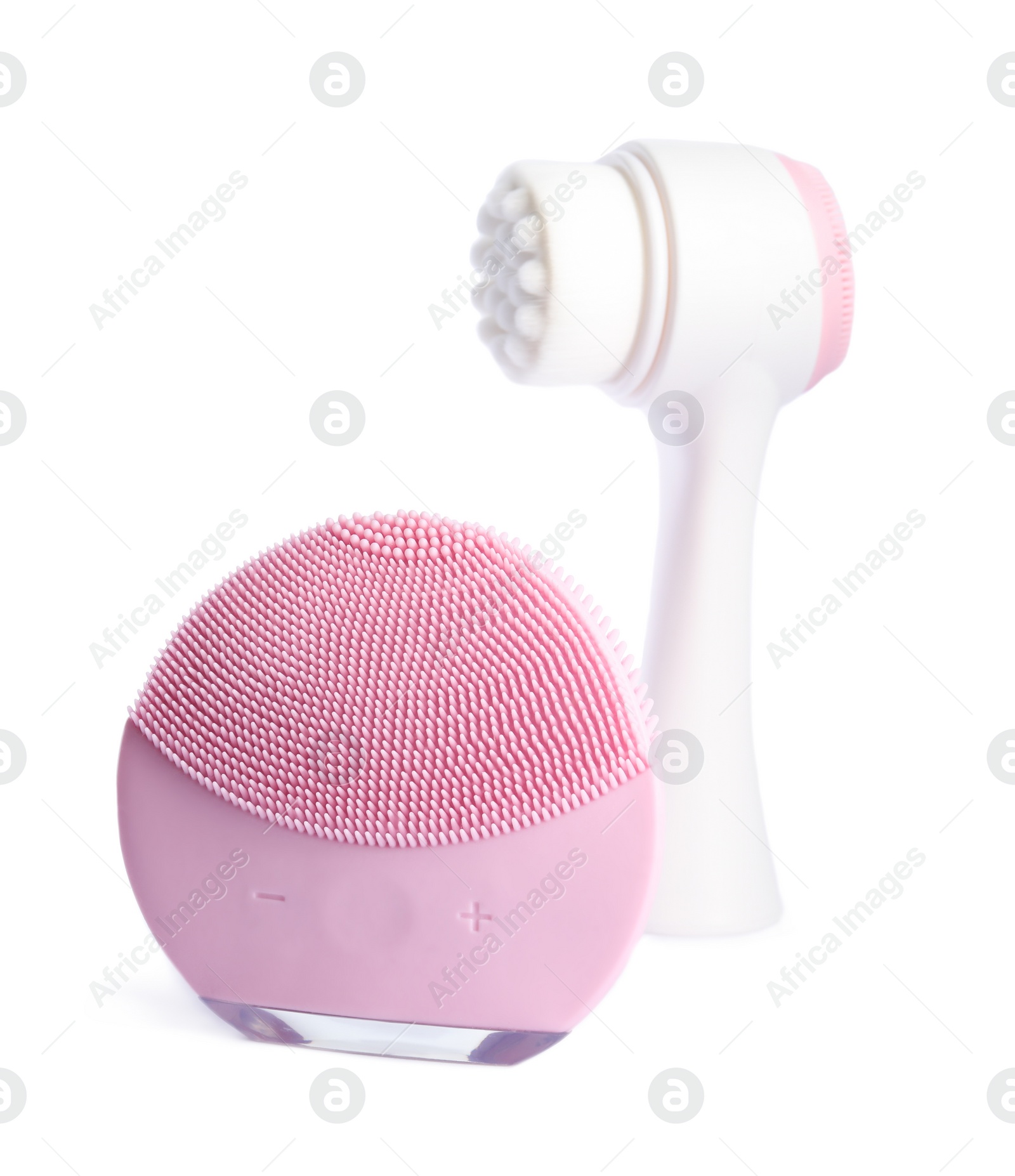 Photo of Modern electric face cleansing brushes isolated on white. Cosmetics tools