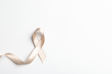 Photo of Grey ribbon on white background, top view. Cancer awareness