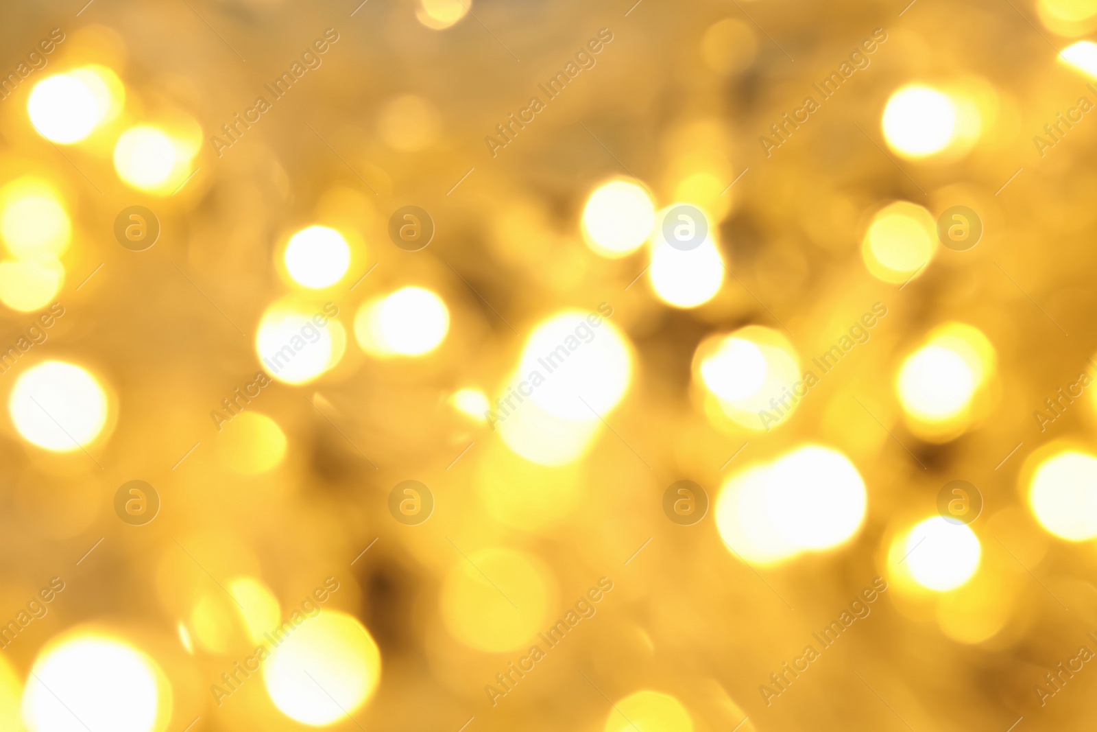 Photo of Blurred view of glowing Christmas lights, closeup