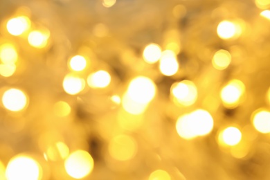 Photo of Blurred view of glowing Christmas lights, closeup