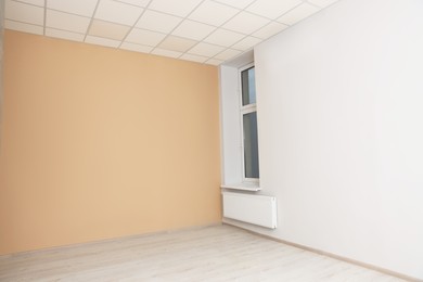 Photo of New empty office room with clean window and beige wall