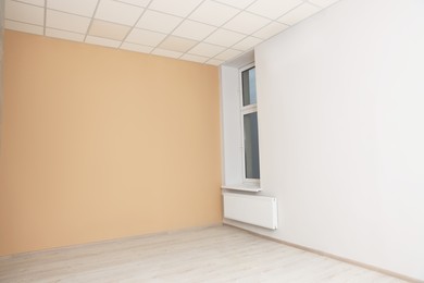 New empty office room with clean window and beige wall