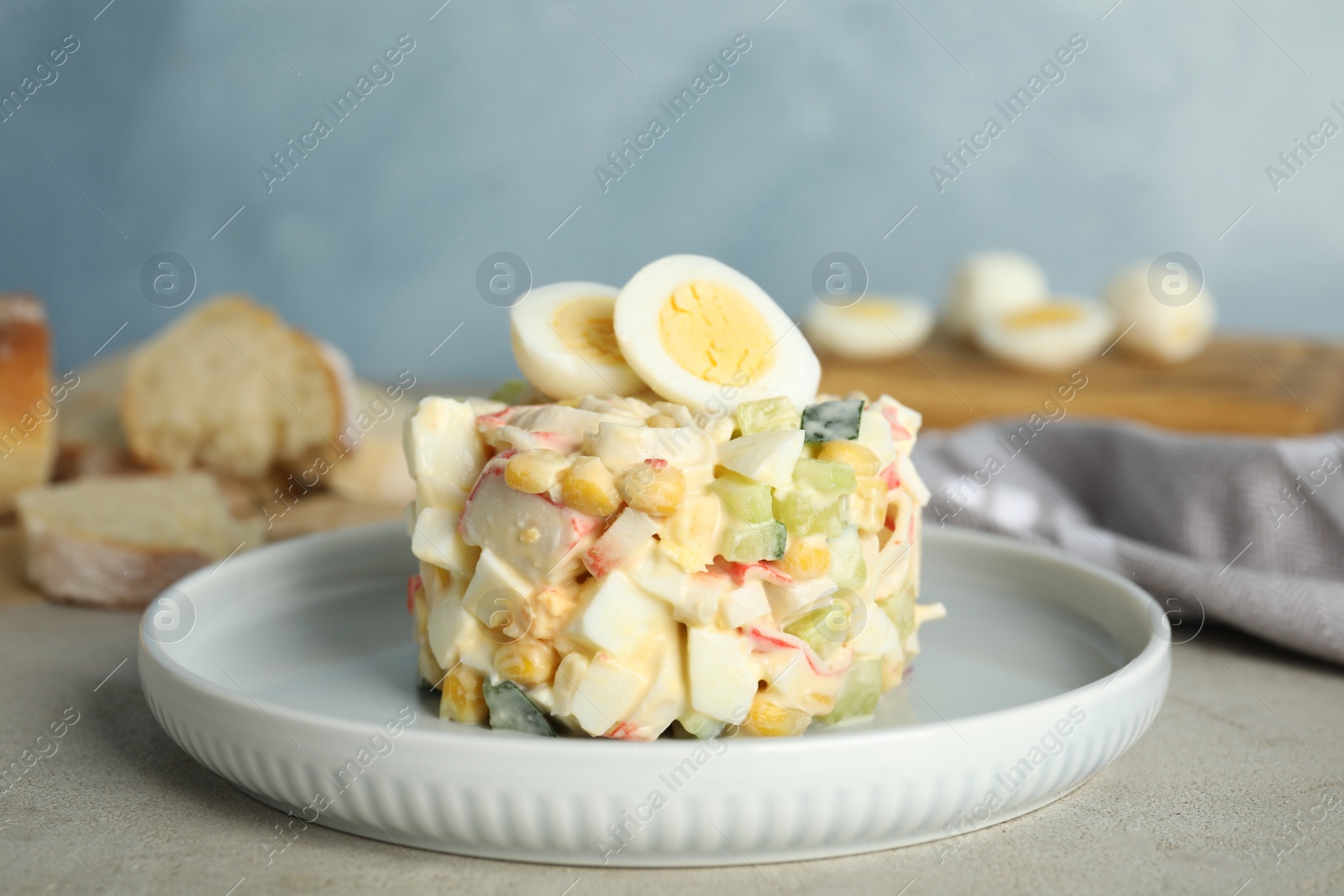 Photo of Delicious salad with crab sticks and eggs on table, closeup