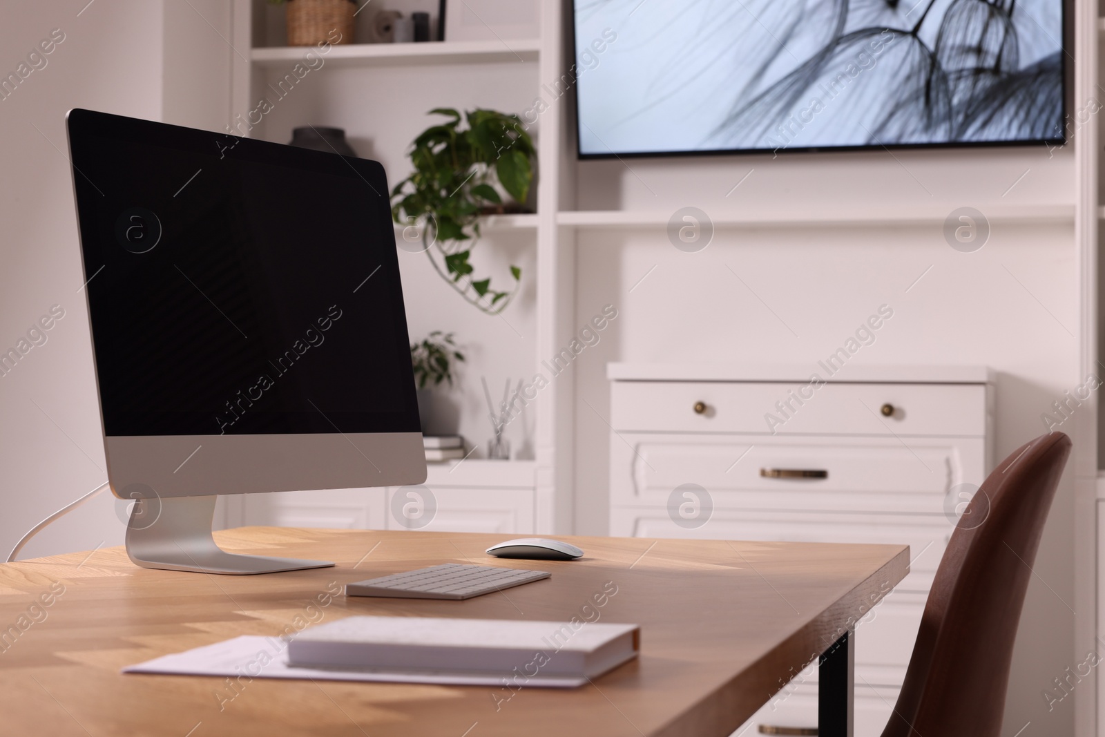 Photo of Interior design. Cosy workplace with computer near tv area