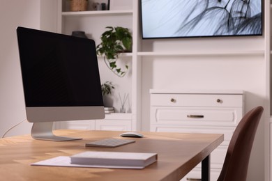 Photo of Interior design. Cosy workplace with computer near tv area